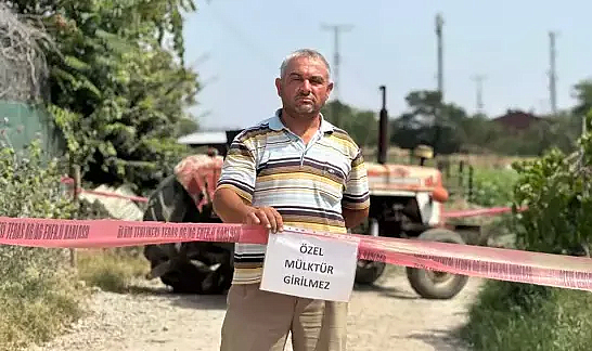 Tapulu arazisindeki yola 'özel mülk' yazısı asıp, ulaşıma kapattı